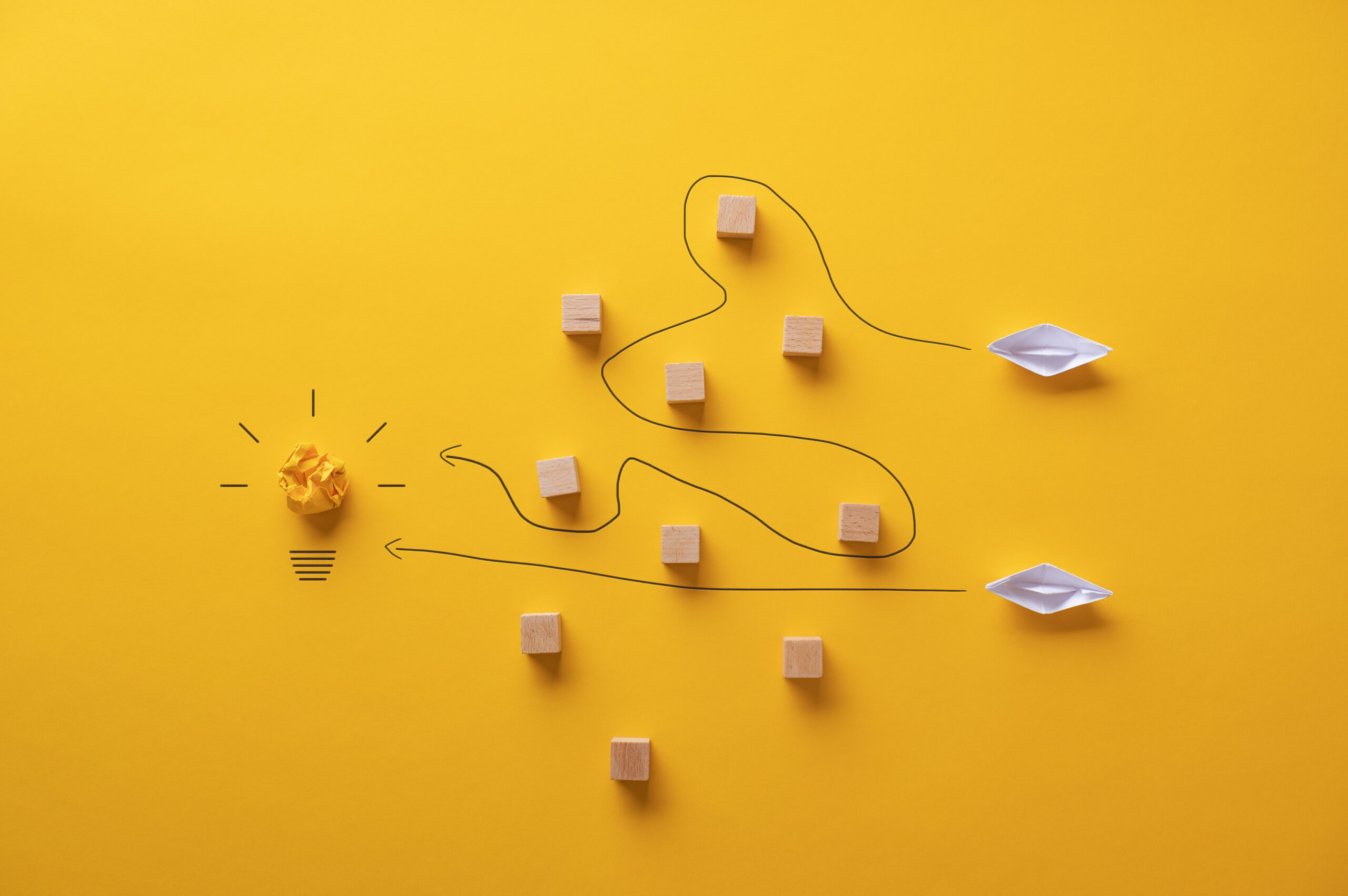 Two,Paper,Origami,Made,Boats,Trying,To,Reach,Their,Goals
